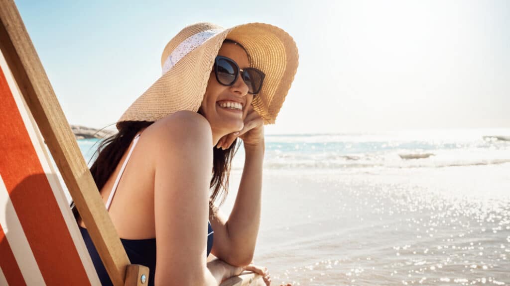 girl with a hat enjoying a beach