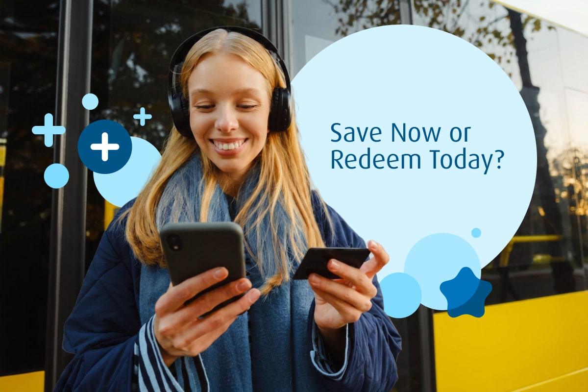 girl happily looking at her phone to redeem points