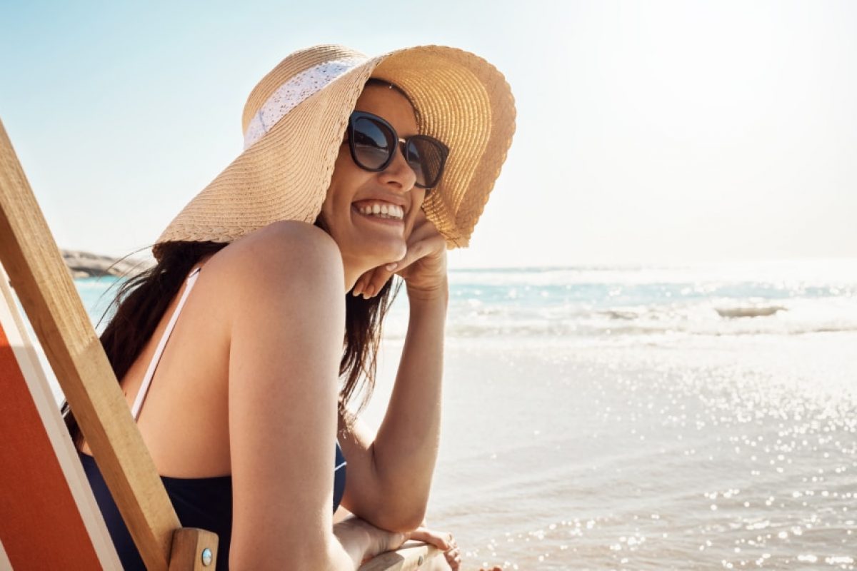girl with a hat enjoying a beach