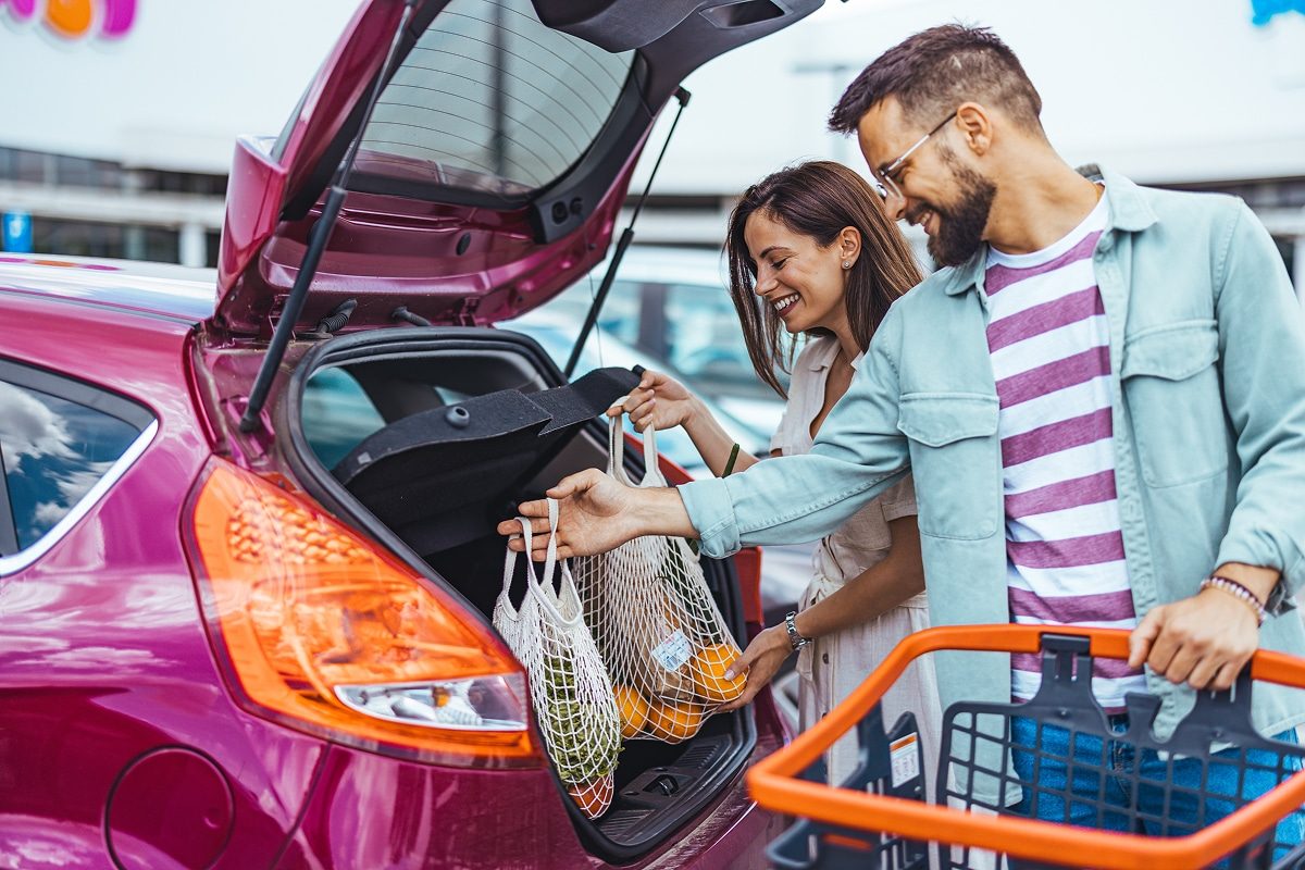Couple putting away groceries in car